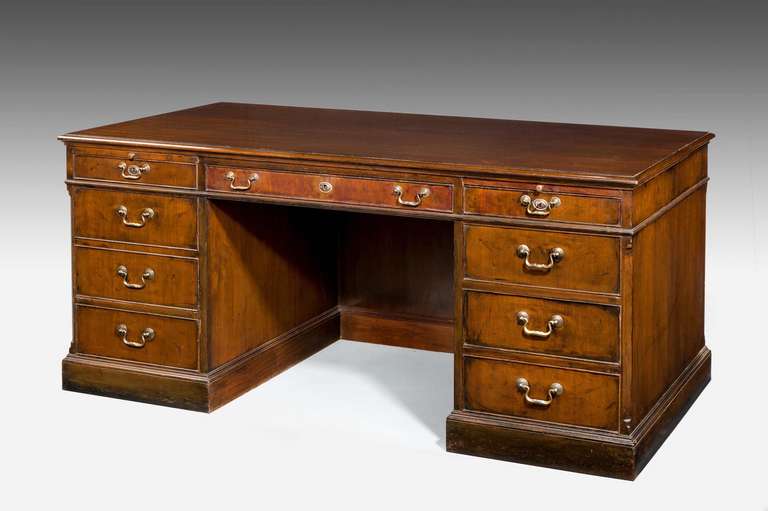 Mid-19th Century Mahogany Nine Drawer Pedestal Desk with original polished top above two pull out slides above the top drawers.
