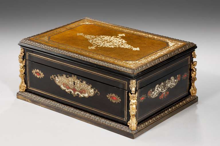 A good French ebonized Box, with well-cast gilt bronze mounts, gilded leather top, the fall front enclosing six drawers.