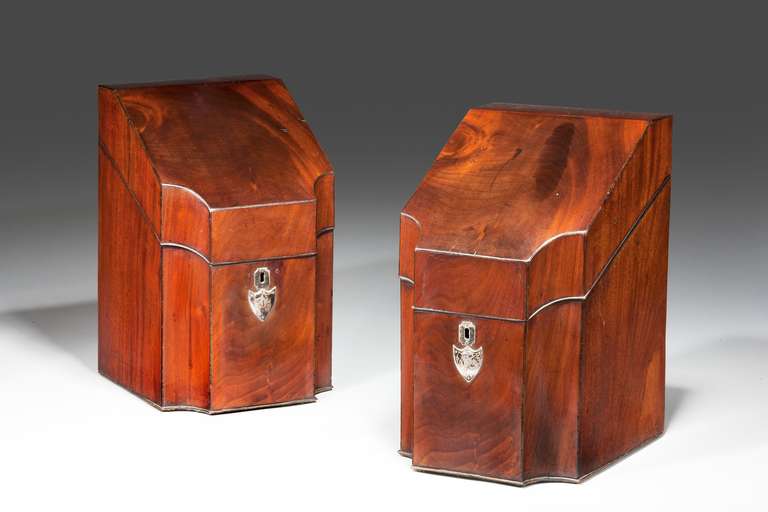 Pair of George III mahogany knife boxes, with concave corners. Well figured timbers with original silver plated escutcheons and mounts.

RR.