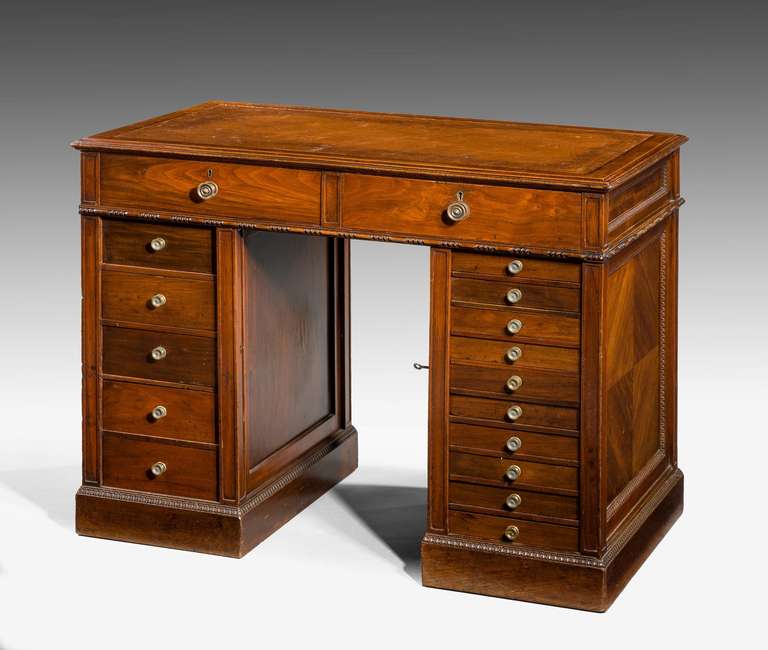 A late 19th century walnut pedestal desk with 17 drawers, quartered ends and panels.

