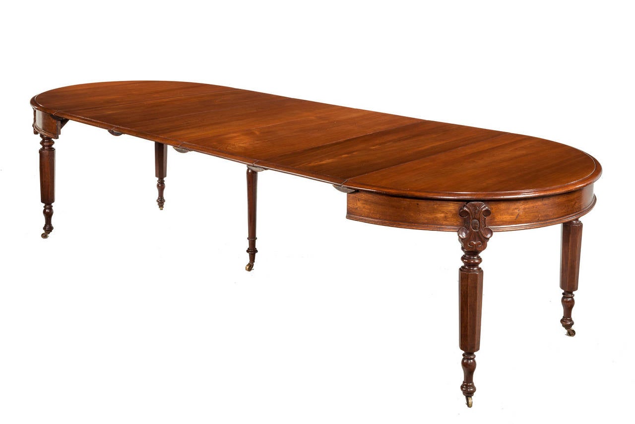 Mid-19th century circular dining table extending with one to six original leaves. Hexagonal facetted supports terminating in inverted plum feet and retaining original shoes and casters. With an extra and original centre support for when fully