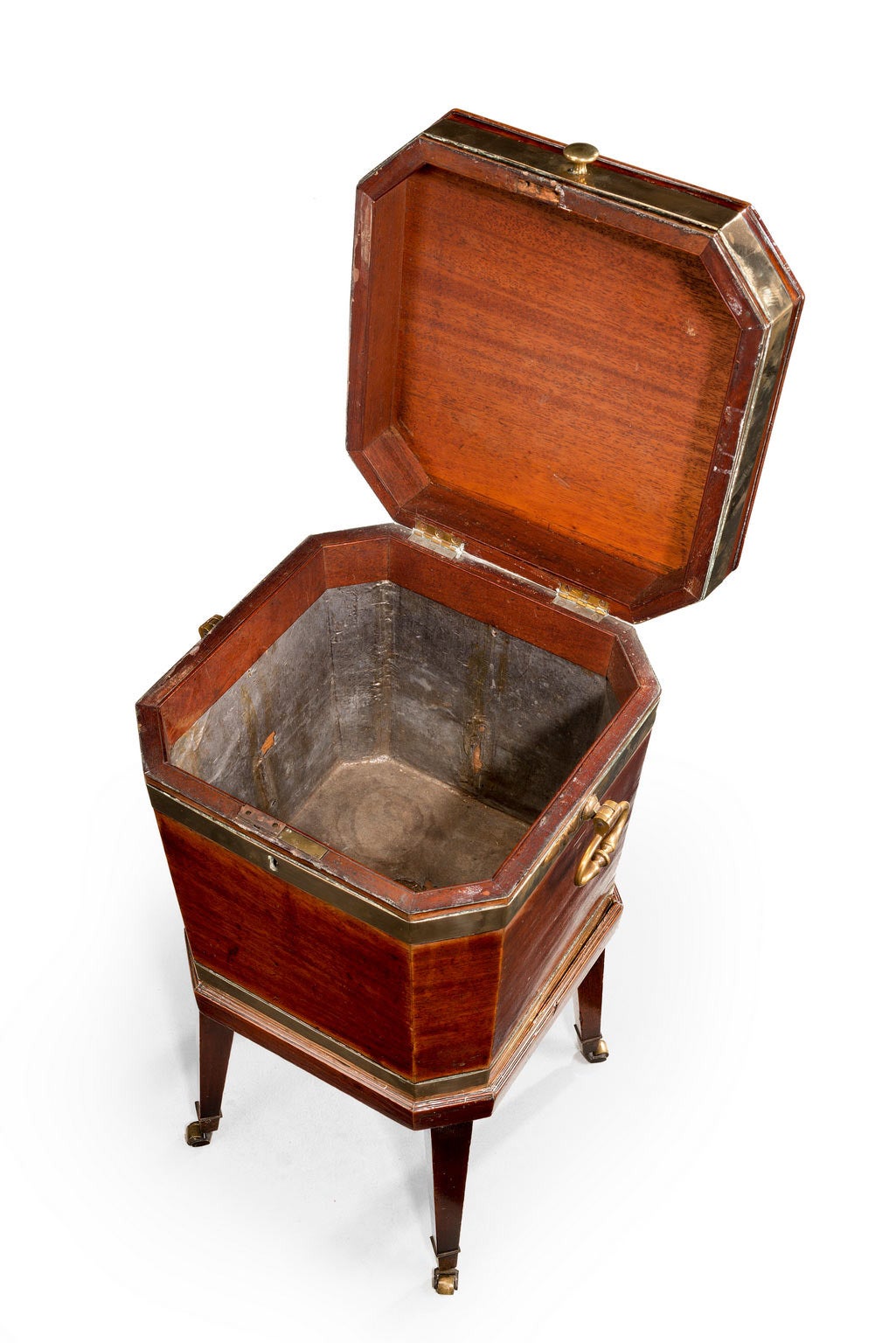 George III period mahogany square cellaret with cantered corners. With very good color and patina, retaining the original hammer lid lining. Brass bindings and massive drop handles. Tapering supports terminating in brass shoes and casters.