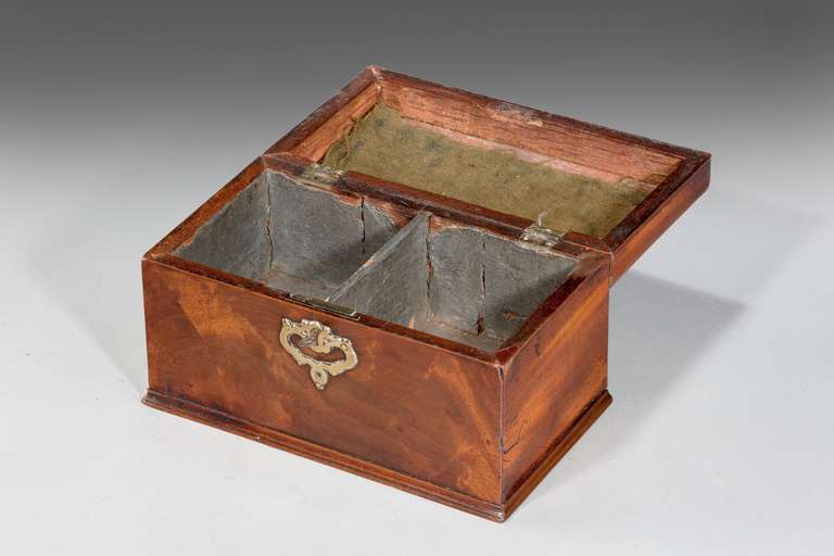 Chippendale period mahogany tea caddy, the interior retaining original tinned paper lining. Very well shaped body with original brass handle and escutcheon.

The word tea caddy is believed to be derived from catty, the Chinese pound, equal to