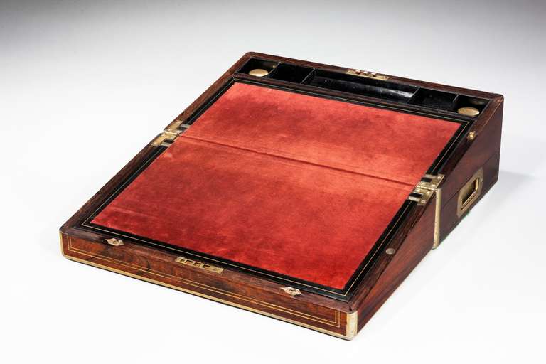 19th century period brass bound writing box with inset velvet interior slope and two fitted ink bottles.