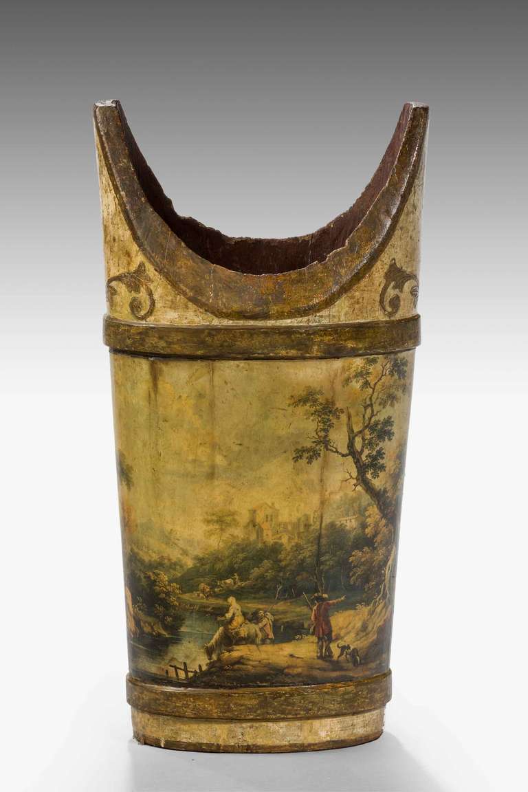 A 19th century Italian oval timber container, finely painted with figures in a wooded landscape, the gilding now oxidized.