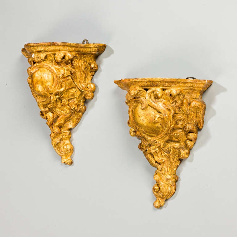A good pair of mid-19th century giltwood brackets of cornucopia form, the soft gilding attractively worn, largely original.