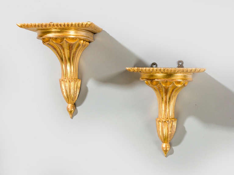 A pair of neoclassical giltwood brackets of flared cornucopia design.

RR.