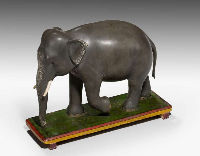 An amusing early 20th century Indian papier mâché elephant, shading to bronze with splash white decoration.

Starting circa 1725 in Europe, gilded papier mâché began to appear as a low-cost alternative to similarly treated plaster or carved