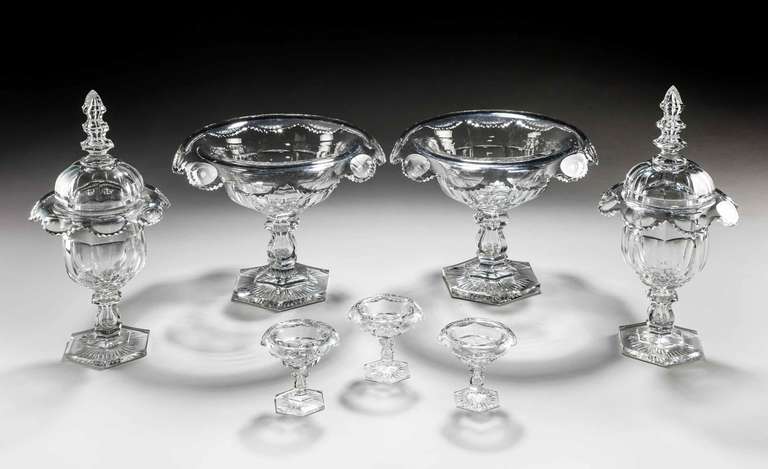 A fine suite of seven mid-19th century table glass, one pair of comports, one pair of lidded sweetmeat dishes and three salts with star cut hexagon bases with knopped section stems.

RR.