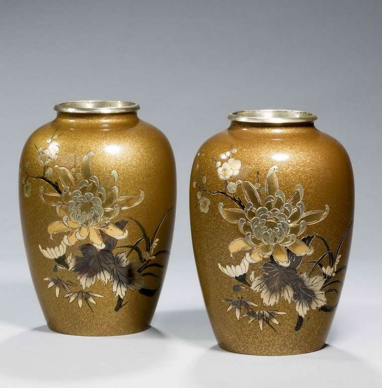 Pair of Japanese 19th century bronze vases decorated with incised flowers and foliage on a gold splashed background.