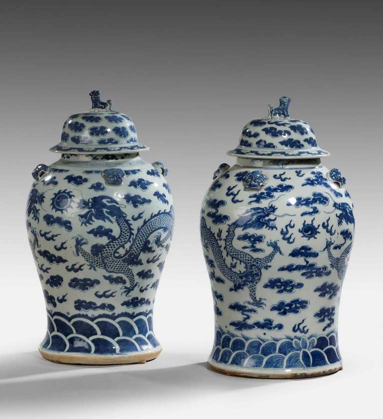 A Good Pair of Mid-19th Century Chinese porcelain lidded Vases, of ovoid form, the upper shoulders mounted with exotic masks, the lids surmounted with kylims.