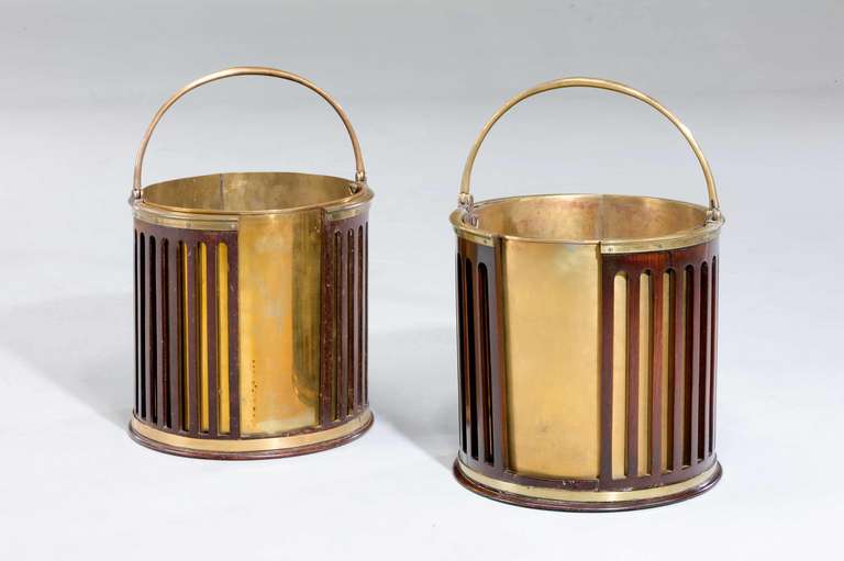 A near pair of George III period mahogany plate-buckets now with a fitted brass liners, the buckets, circa 1780.

RR.