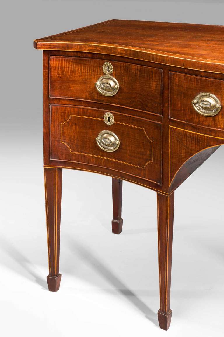 George III period serpentine 'fiddleback' mahogany sideboard of small proportions on square tapering supports, the top edge cross-banded. 

Provenance:
Sideboards are an item of furniture traditionally used in the dining room for serving food, for