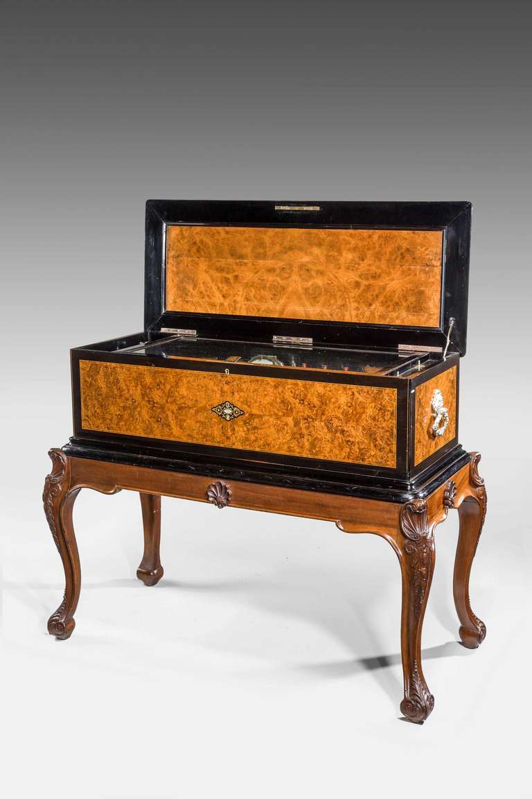 A superb Swiss massive walnut music box on stand by Jacob Freere, with drums and seven butterfly bells and symbols signed by Piallard of New York.

RR.