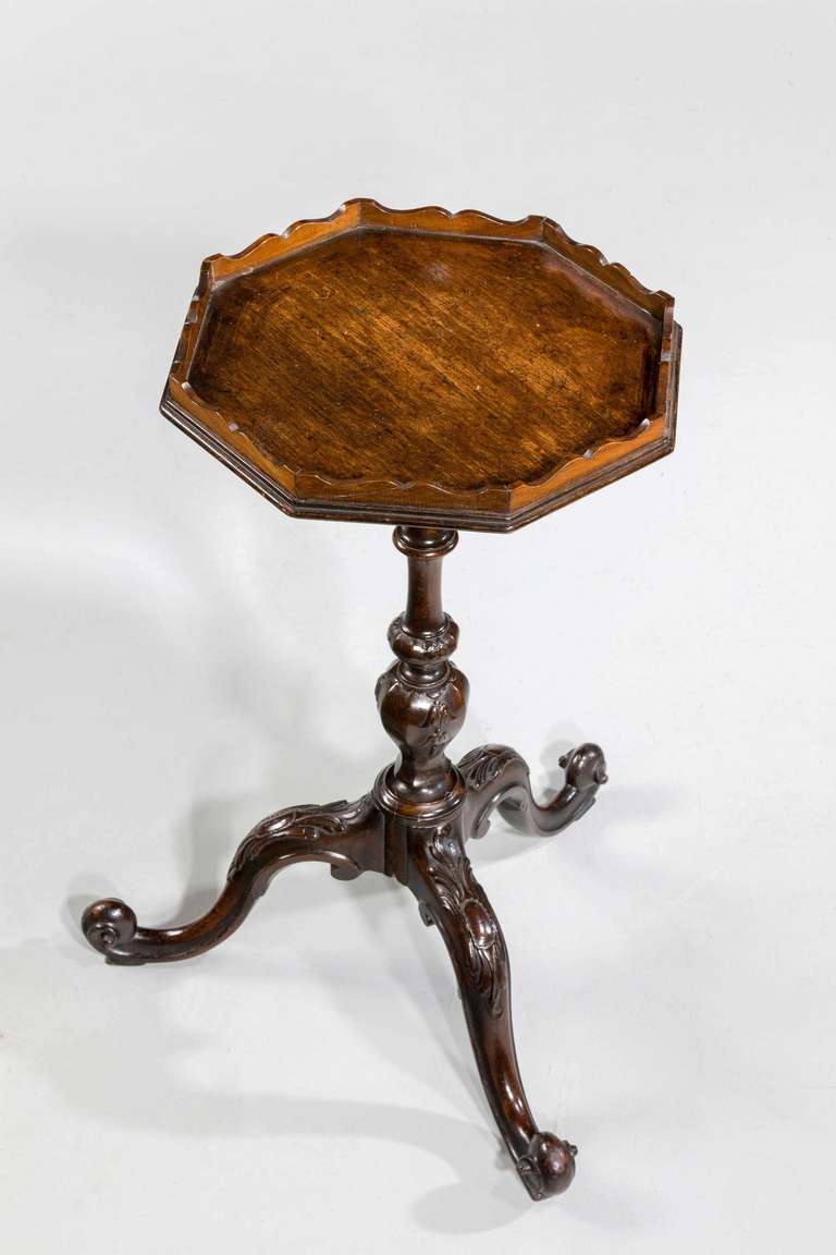 A pretty mahogany kettle stand with a shaped gallery top over a well carved slender stem, the cabriole supports with cabochons, design circa 1760 executed circa 1890.

