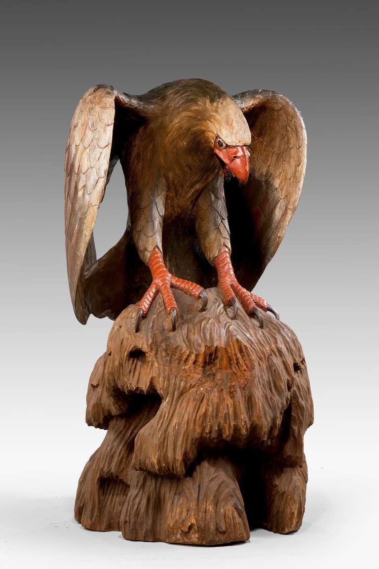 A massive carved and polychrome figure of an Eagle on a simulated rocky base, carved from the solid.