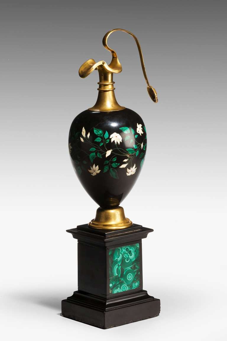 A large 19th century Ashburton gilt bronze Ewer of neoclassical form, the square base inset with a malachite panel, the flowers and leafs of various marbles.