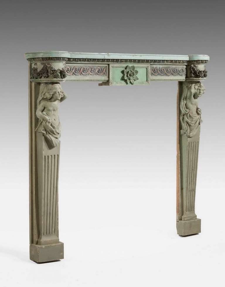 Well carved 19th century pine and gesso fire surround with fruiting vines and with tapering jambs. 

Provenance:
By the 1800s most new fireplaces were made up of two parts, the surround and the insert. The surround consisted of the mantlepiece and