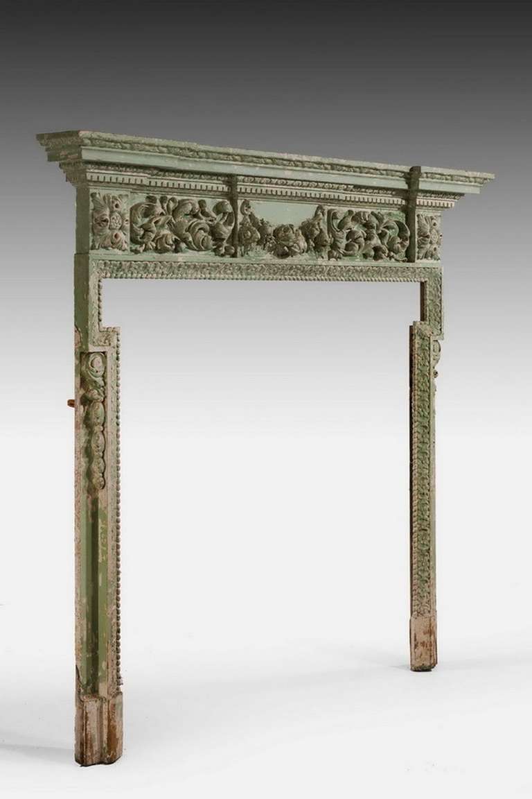 Mid-19th century pine and gesso fire surround with heavily pronounced decoration to include fruit and foliage. 

Provenance:
By the 1800s most new fireplaces were made up of two parts, the surround and the insert. The surround consisted of the