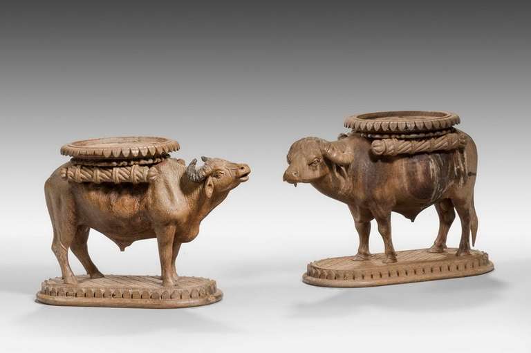 A finely carved pair of water buffalo sculptures with pommelled skin decoration.