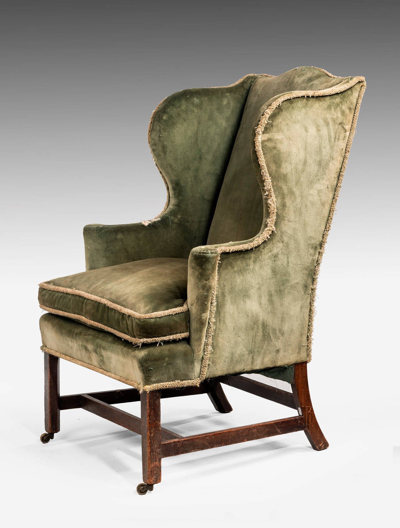 A Chippendale period mahogany framed Wing Chair. With square shaped supports joined with cross stretchers, slightly flared arms. Now requiring re upholstery. 

An 18th or 19th century wing chair is an easy chair or club chair with 