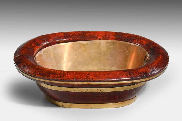 A late 19th century elm oval baby’s bath coopered in traditional manner with a modern made brass liner the top, beautifully figured in oysters. South china.