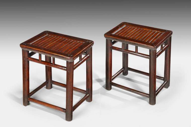 An attractive pair of 19th century stools, on sturdy four section supports with cross stretchers.