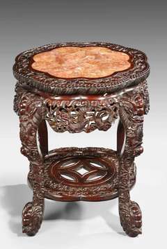 An Late 19th Century Oriental Hardwood Two Tier Carved Stand