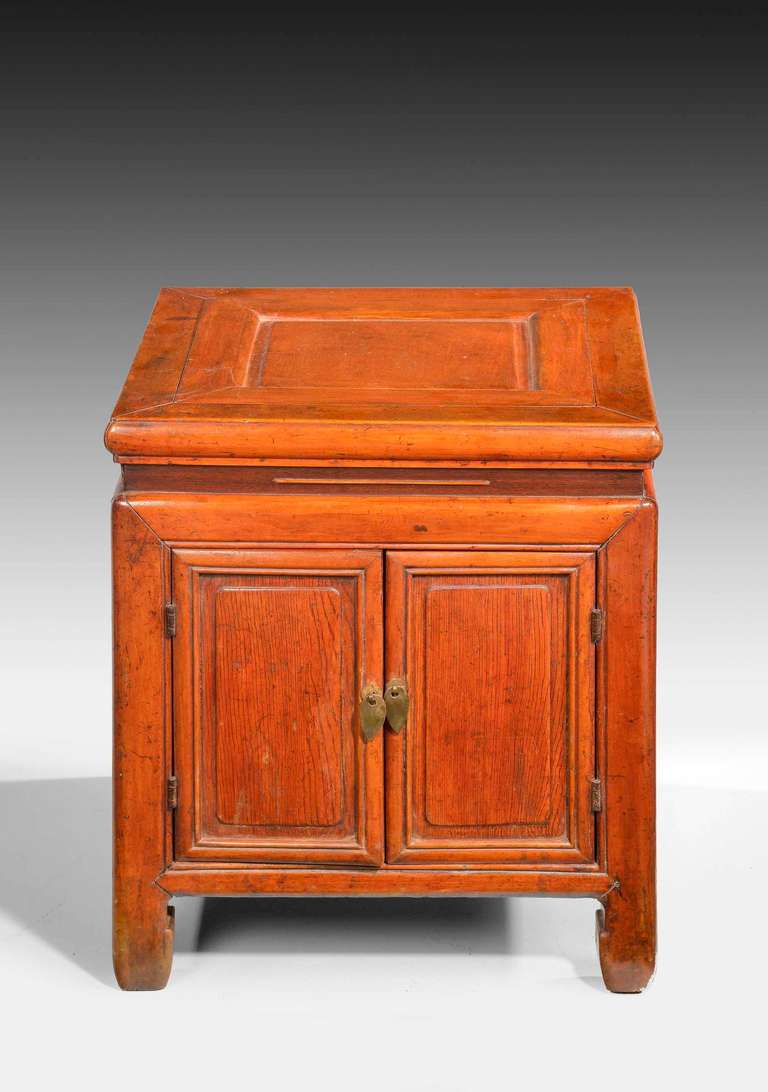A small, 19th century, Oriental elm enclosed stool table, the base section with a cupboard and the central unit to the top, lifting and removable. South China.