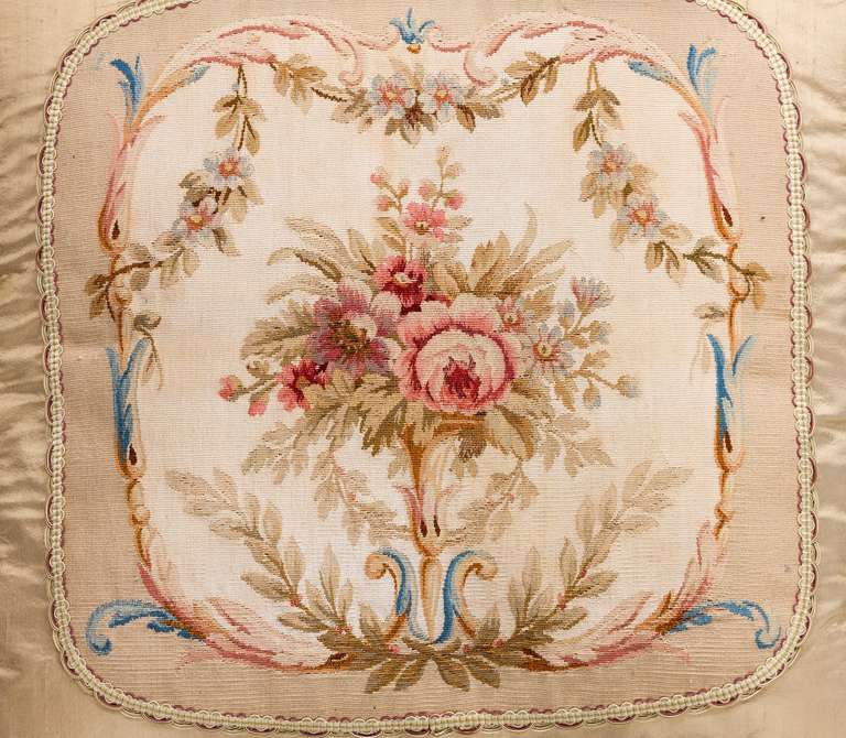 French, last quarter of the 18th century. Wool with silk highlights, flowers and foliage to the centre within a framework of stylized leaves.

RR.