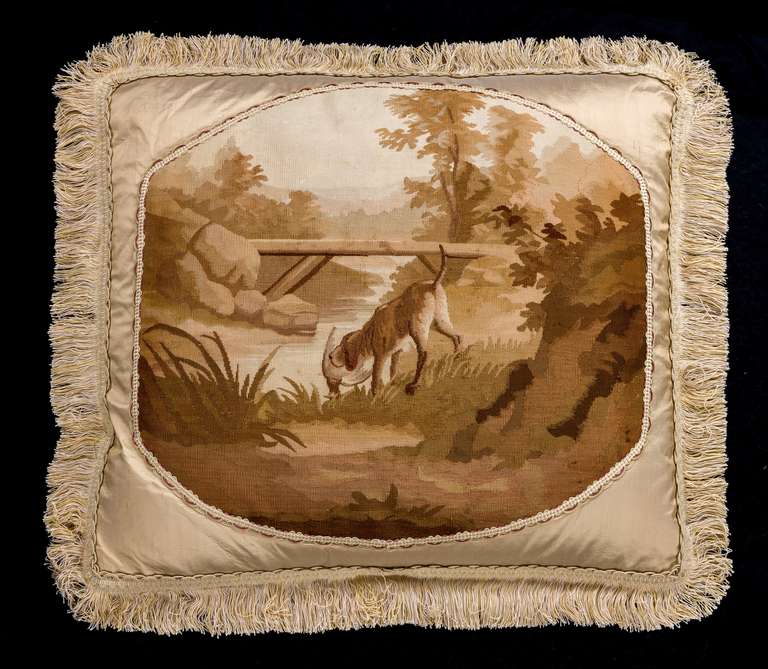 Late 18th-early 19th century tapestry cushion, wool, a dog retrieving a rather fabulous bird within a rocky landscape. Muted champagne, beige and soft brown colours.

RR.