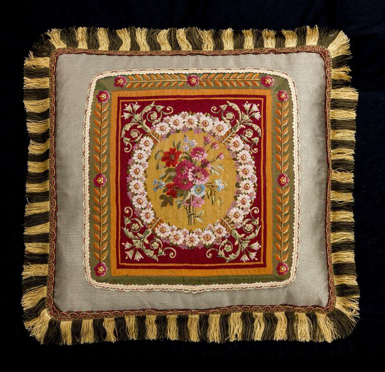 English or French, wool and silk, late 18th century. Flowers within a continuous border. The central background of gold within a vibrant claret outer border.
  
    

RR.