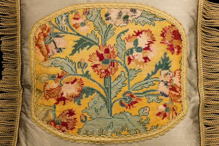 A late 18th century English wool work cushion, gros point, with stylized foliage emanating from a central stem.

RR.