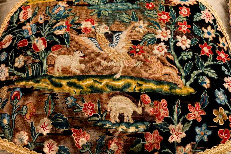 A large mid-18th century cushion, French or English, wool, with brilliantly executed stitching in petit and gros point, with silk highlights. An exotic bird with animals.

RR.