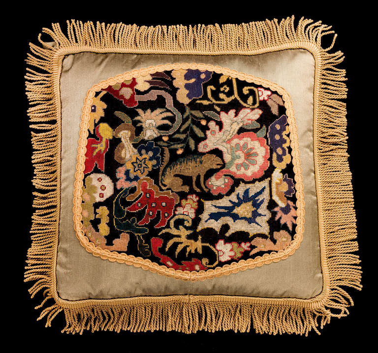 Mid-18th century, French, wool with silk highlights. An unrecognizable, wild looking, exotic animal within a strong gold framework of scrolls and foliage.


