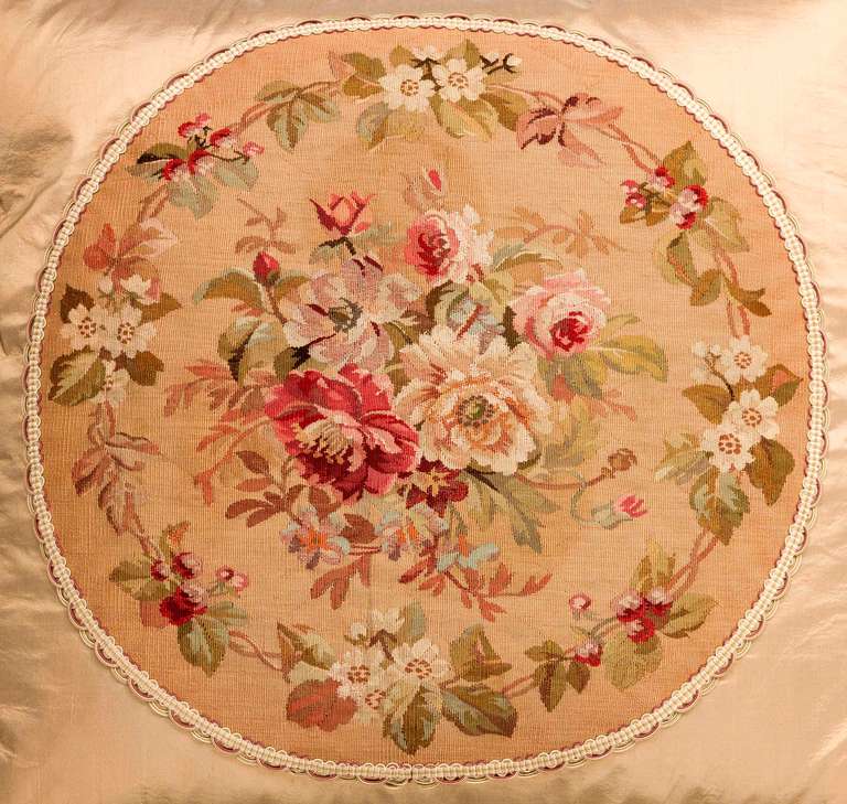 Late 18th century, French, wool with silk highlights. A central bouquet of flowers within a continuous border of flowers and foliage, overall muted shades.

RR.