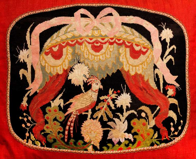 Late 18th century, probably English, gros and petit point wool. An exotic bird within a caparison border. 

RR.

 