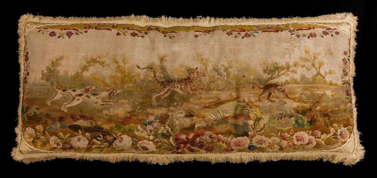Mid-18th century, French pillow cushion, wool with silk highlights. A hunting scene taken from Aesop’s fables, muted fawns, gold and coffee colours.

RR