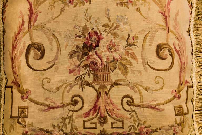 Late 18th century, French, wool with silk highlights. A vase of flowers within an old-gold scrolling framework.

RR.

 