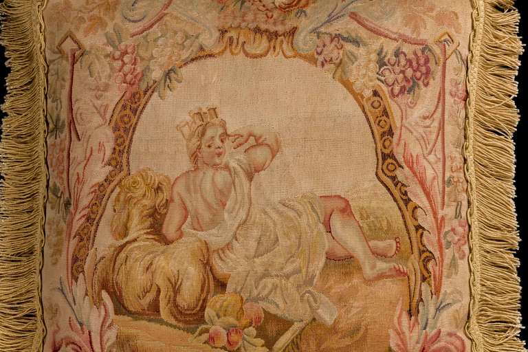 Late 18th century, French, wool with silk sky and highlights. A reclining figure with a golden cassone within a scroll work.

RR
