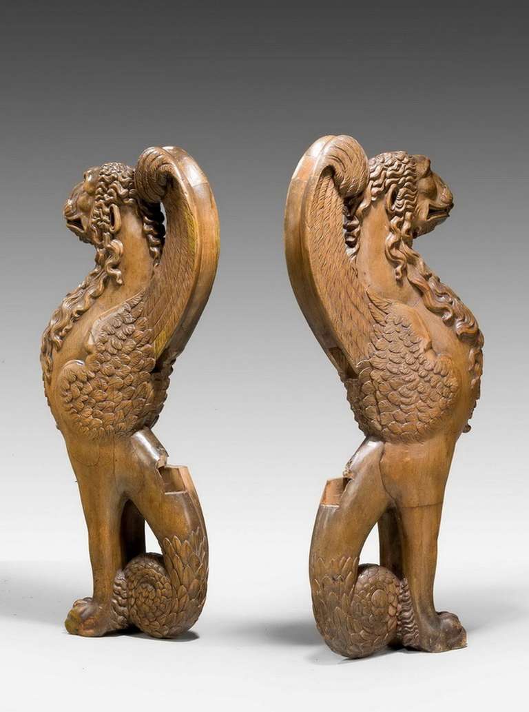 Pair of 16th century French walnut chimeras, vigorously carved with cut insets where the original seat would have been. Would make an imposing peer table or bench.