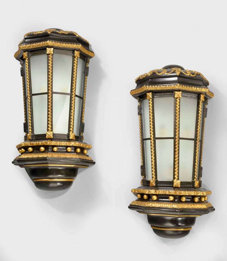 An exceptional pair of late 19th century wall lights. The four glazed panels held between spiralled astragal circular ball decoration to the lower borders with banding in gold leaf. The whole in the finest quality and design.

