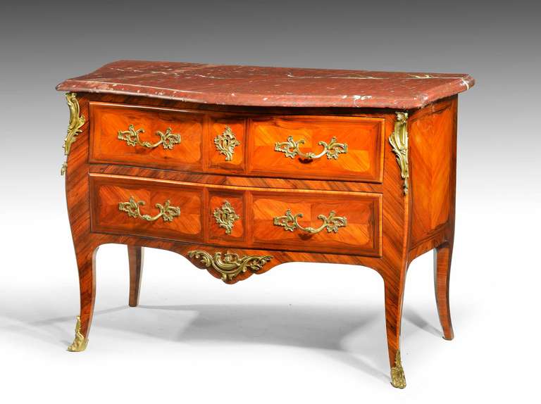 A good mid-19th century French kingwood and rosewood bombe commode retaining it's original handles and sabots with its original very well figured marble top. Bombe sides which are quartered.

Originally, in French furniture, a commode introduced