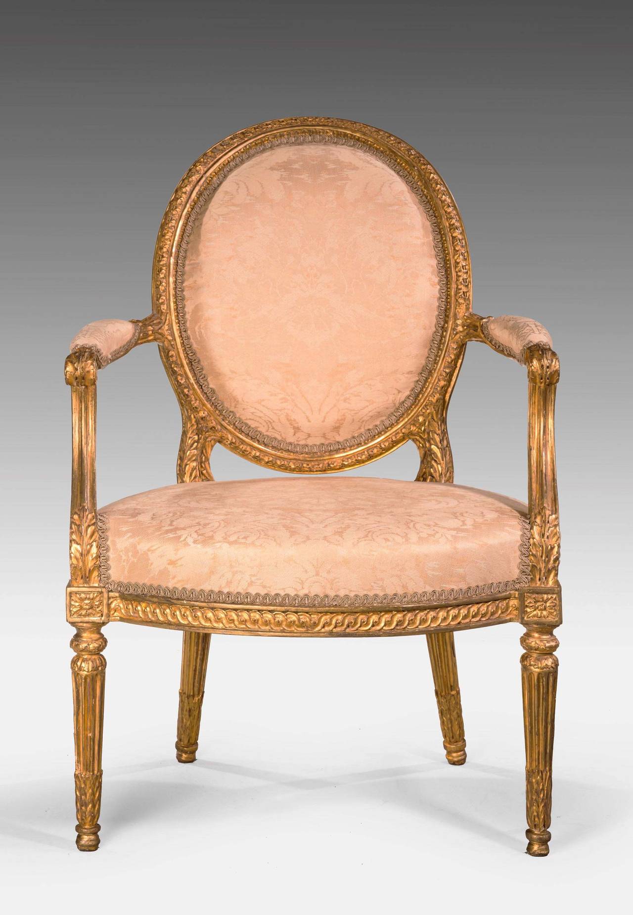 A very beautifully carved late 18th century giltwood armchair. The oval back with continuous finely executed work. Back support with scroll work and largely original gilding.

 This chair holds the plaque of C. Maller and Company,