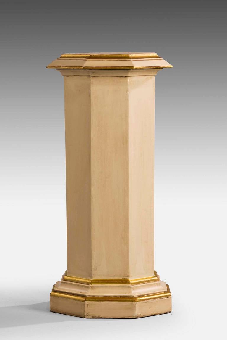 A parcel-gilt hexagonal ivory colored column. The waisted centre section with flared top and bases.