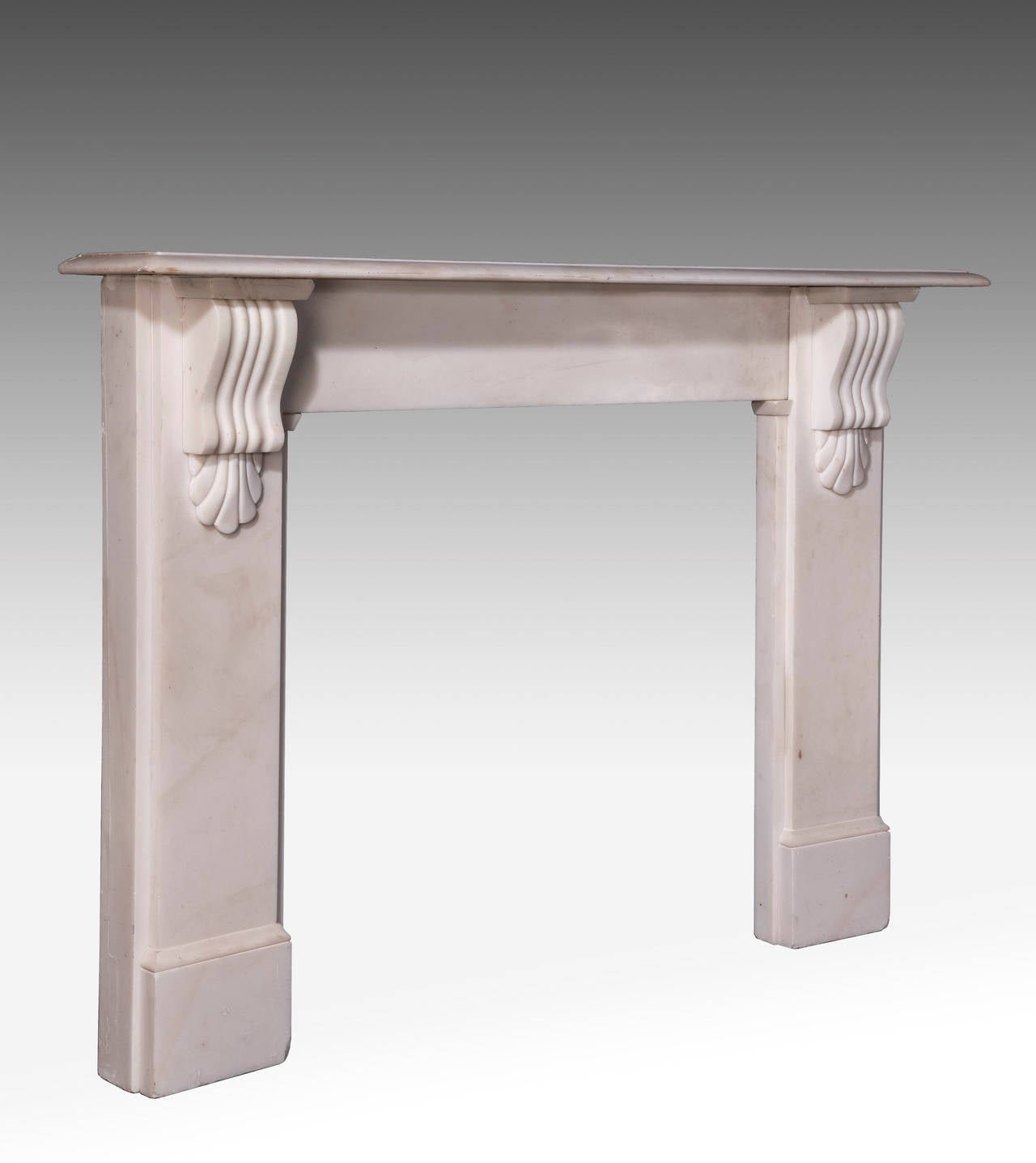 White marble fire place surround of very simple form. The shelves supported with carved boss’s. Ex Private house in Mayfair London W1.

Shelf length - 48.25 inches.
Shelf depth - 14.00 inches.
Opening height - 33.50 inches.
Opening width 33.75