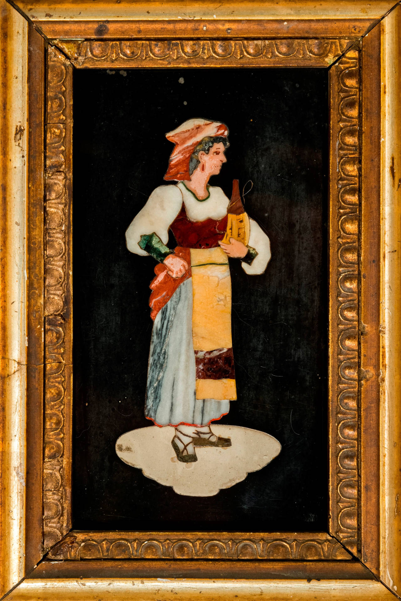 A charming small Scagliola figure of a girl within its original frame.
