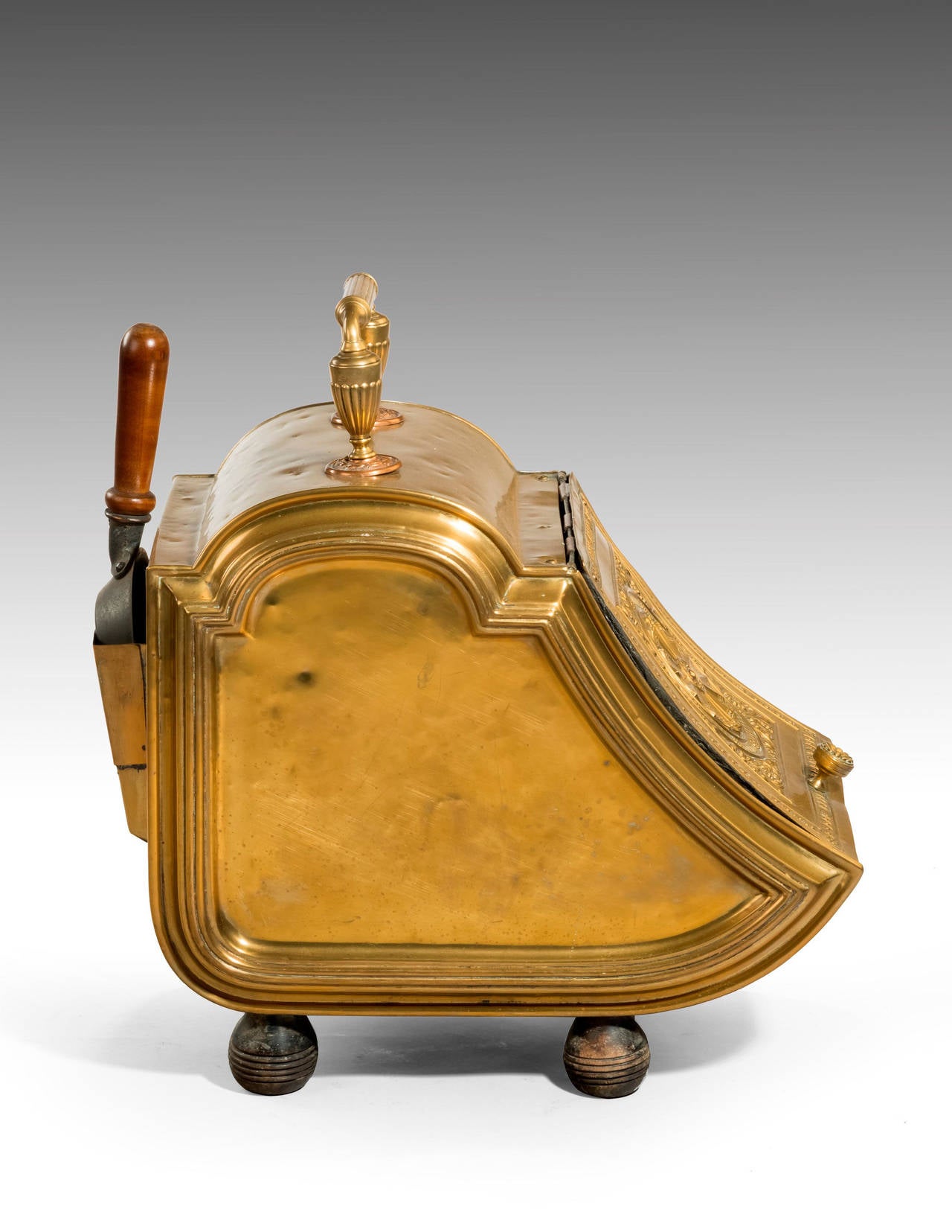 A shaped and embossed 19th century coal podium with a lift up lid to the central section. Heavily embossed details fitted to the shell at the back. The Shovel period but not original.