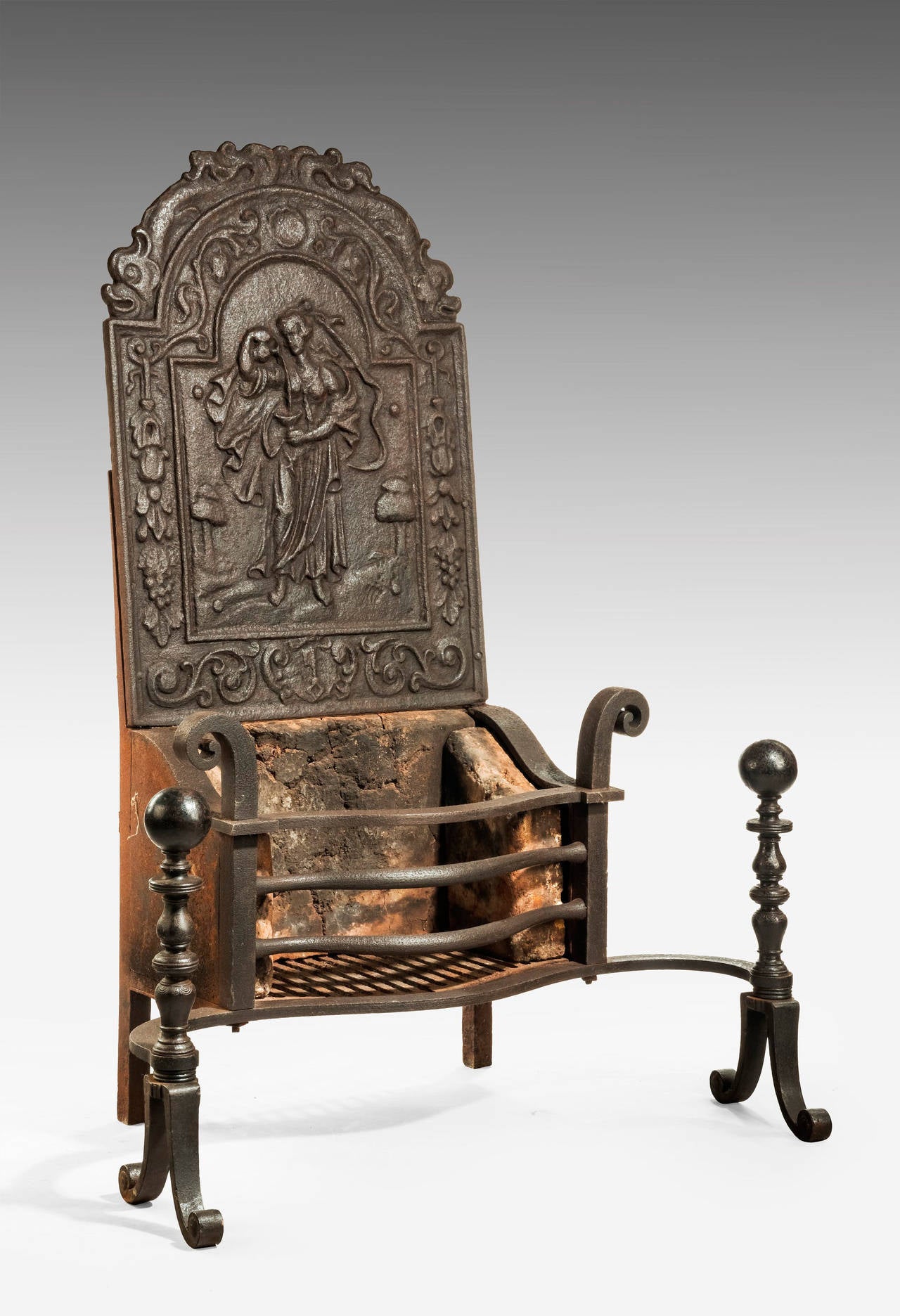 A cast iron grate with practically unusual high top, the panel with a maiden pouring liquid into a neoclassic goblet.

