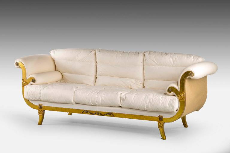 A Regency style giltwood sofa. On sabre supports, the uprights with well defined carved sections.

To await clients choice of material.

RR.